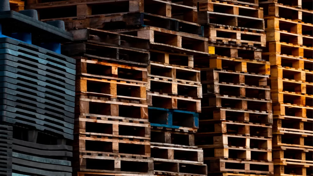 A stack of wooden and plastic pallets